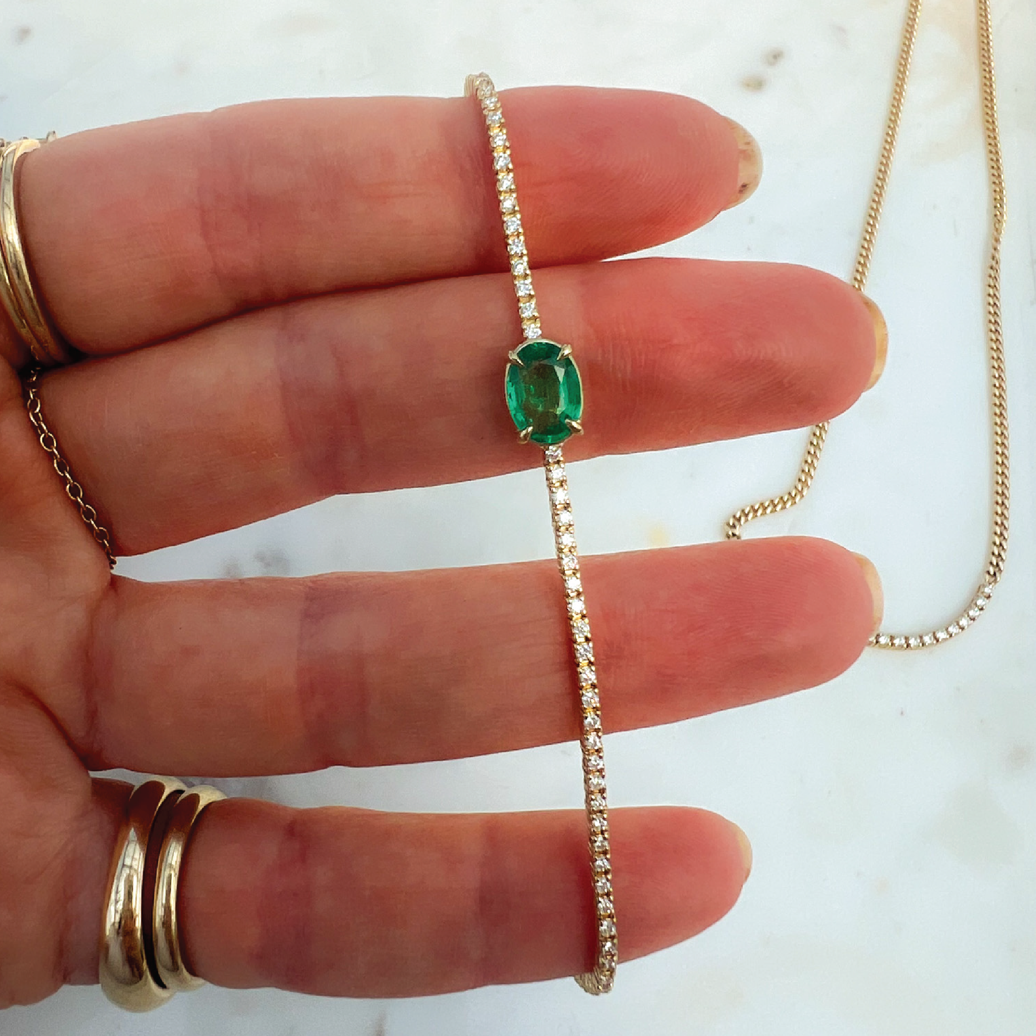 Oval Cut Emerald Whisper Tennis Bracelet