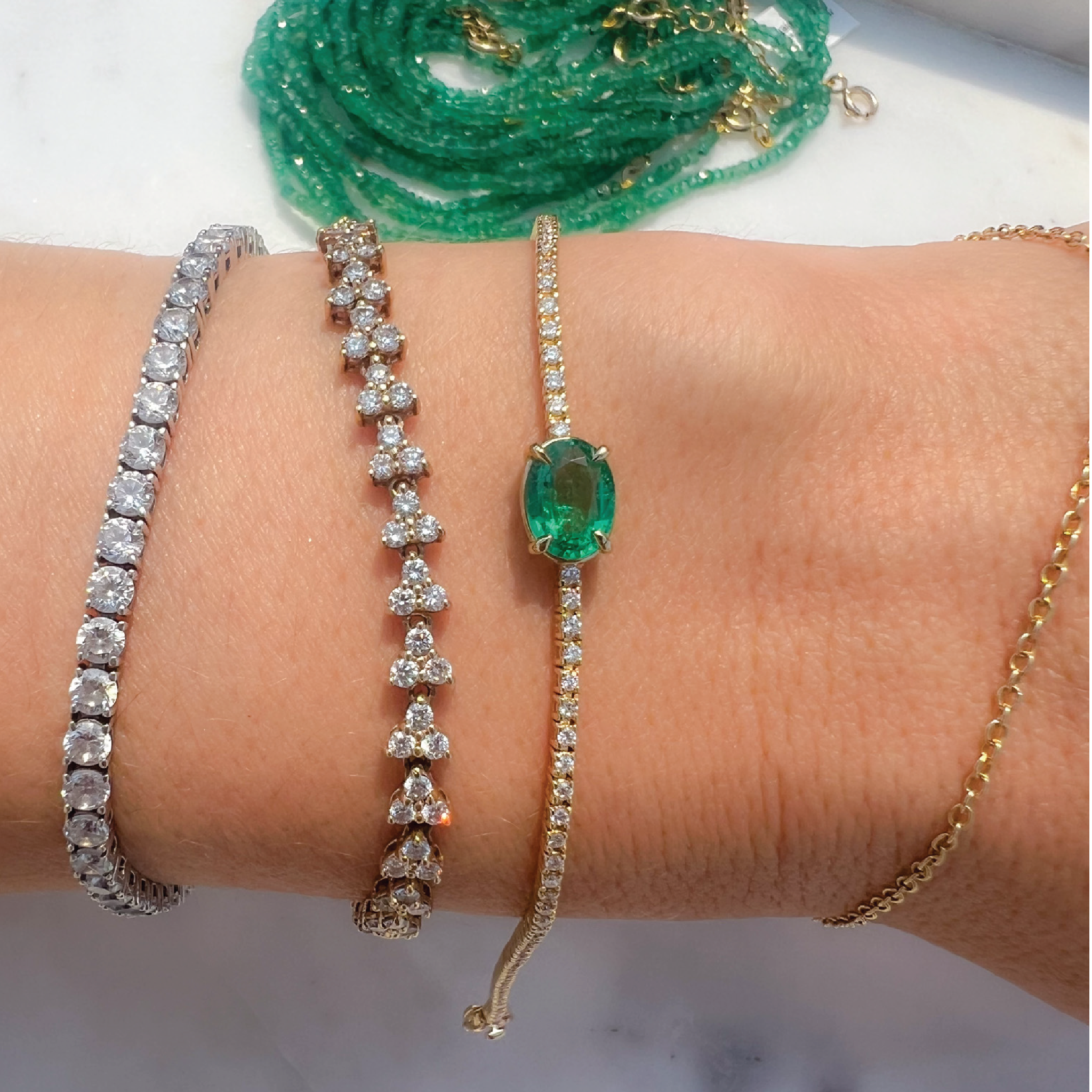 Oval Cut Emerald Whisper Tennis Bracelet